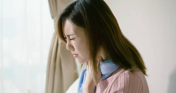 asian woman has sore throat asian woman sick and has sore throat in the bedroomasian woman sick and cough in the bedroomasian woman sick and sneeze with tissue paper in the bedroom bed of hay stock pictures, royalty-free photos & images