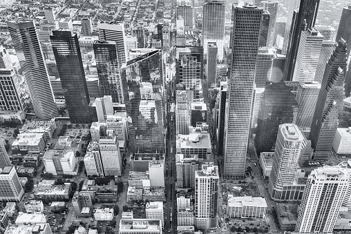 Black and white aerial view of the downtown district of Houston, Texas shot from an altitude of about 1500 feet.