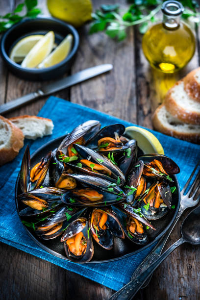 istock Steamed mussels on rustic wooden table 1184412334