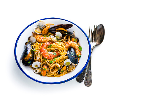Typical Italian food: seafood pasta plate shot from above on white background. XXXL 42Mp studio photo taken with Sony A7rii and Sony FE 90mm f2.8 macro G OSS lens
