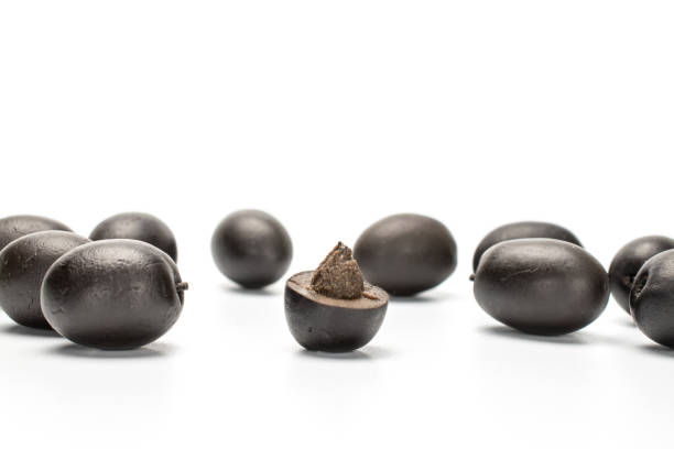 istock Black canned olive isolated on white 1184412839