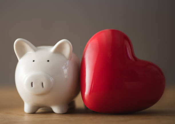 Piggy bank with red heart stock photo