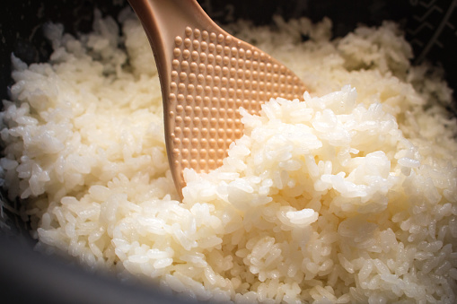 The close up image of Japanese steamed rice in rice cooker.