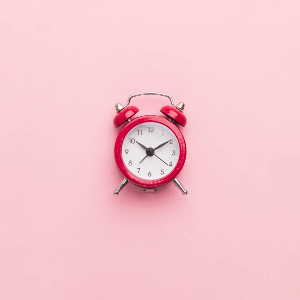istock Red toy alarm clock on pink background 1184417634