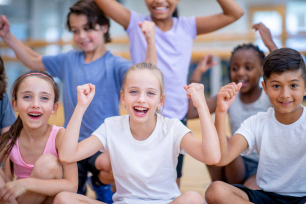 istock Strong Elementary Kids in Gym Class stock photo 1184418211