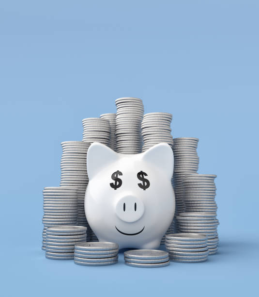 istock Coin Stacks with Piggy Bank on Blue Background 1184420199