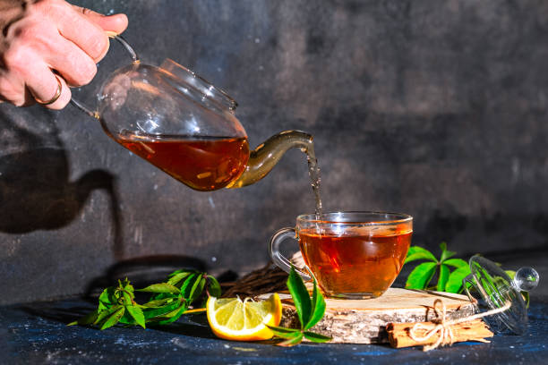 istock Tea cup with hot tea and tea pot. Place for text . 1184420427