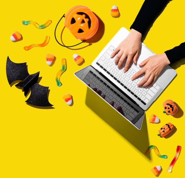 istock Halloween decorations with person using a laptop computer 1184421460