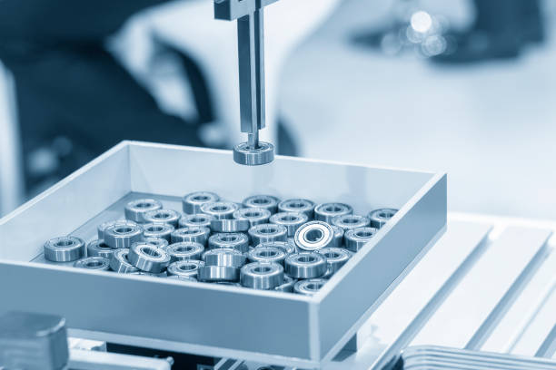 istock The robotic  arm system  for transfer the cylindrical rolling bearing in the light blue scene. 1184421854