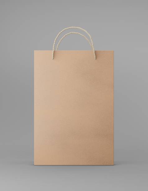 istock Eco packaging mockup bag kraft paper with handle front side. Standard medium brown template on gray background promotional advertising. 3D rendering 1184421902