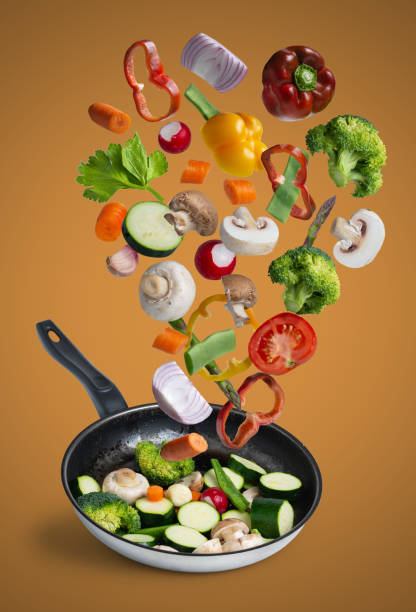 istock grilled fresh vegetables flying isolated on orange background 1184422554