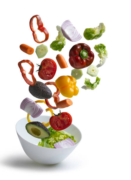 istock Fresh salad vegetables flying isolated from the background 1184422680