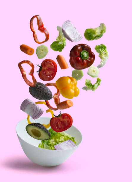 istock Fresh salad vegetables with pink background 1184422681