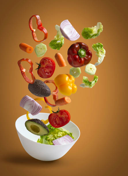 istock Fresh salad vegetables with warm background 1184422682