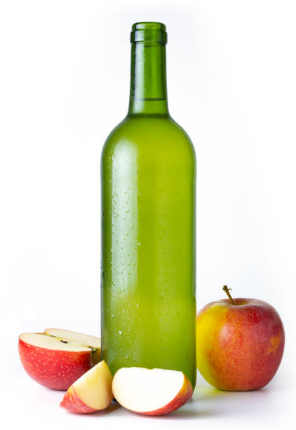 Bottle of very cold cider with apples with white background