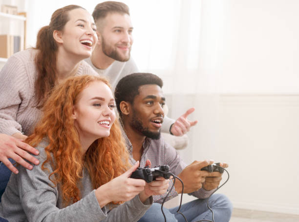 istock Friends competing in video games, having fun at home 1184423080