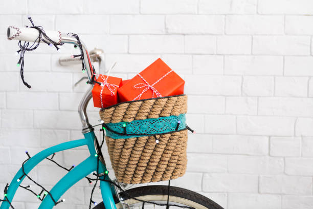 Eco friendly. Christmas gift delivery on creative blue bicycle, white bricks wall, copy space