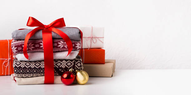 istock Flat lay of Christmas presents and sweaters with patterns 1184423369