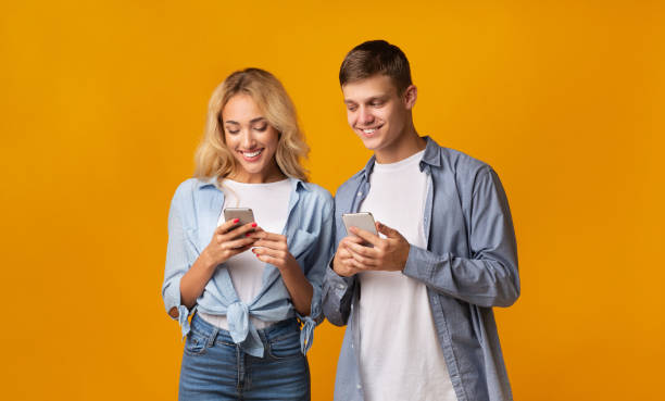 istock Curious boyfriend peeking into girlfriend's smartphone, trying to read messages 1184427251
