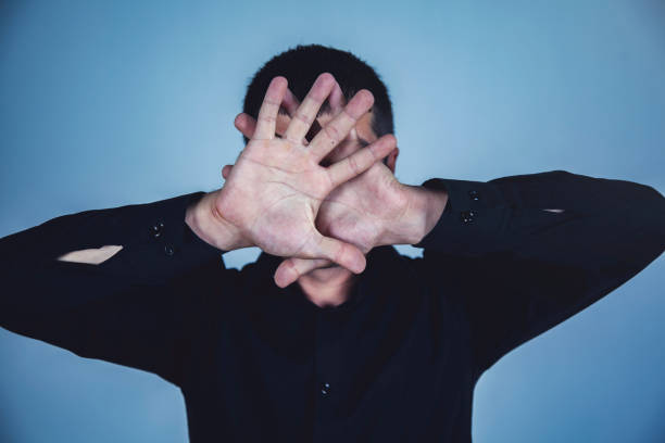 istock man hand stop sign in face 1184430247