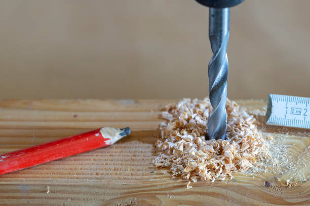 istock metal drill bit make holes in a wooden plank 1184431329