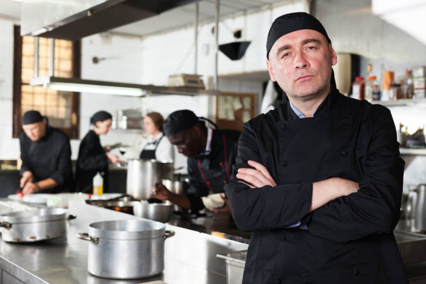istock Confident male chef posing at restaurant kitchen 1184431858