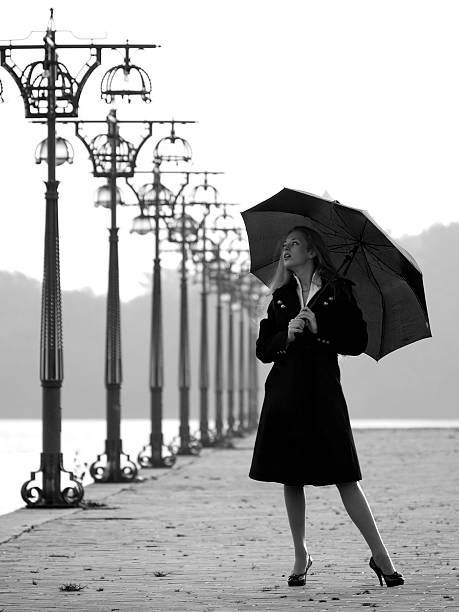 istock Blonde with umbrella on promenade 118443209