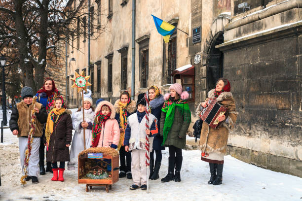 Group of children and adults singing Christmas carols in Lviv, Ukraine stock photo