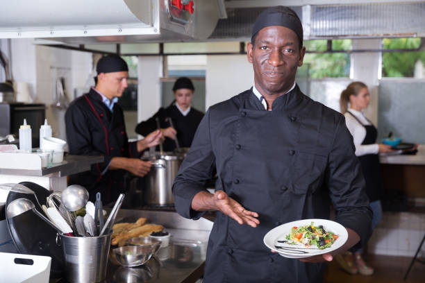 istock African American chef with dish 1184435365
