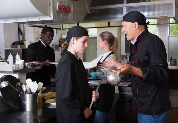 istock Chef dissatisfied with work of girl 1184435374