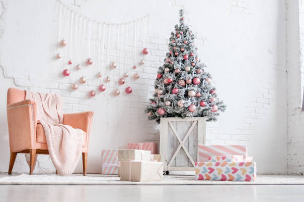 istock Christmas tree decorated with balls next to gift boxes 1184435718