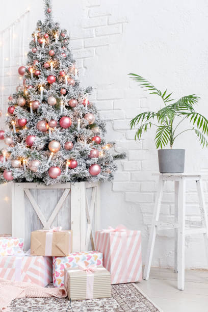 istock Christmas tree decorated with balls next to gift boxes 1184435753