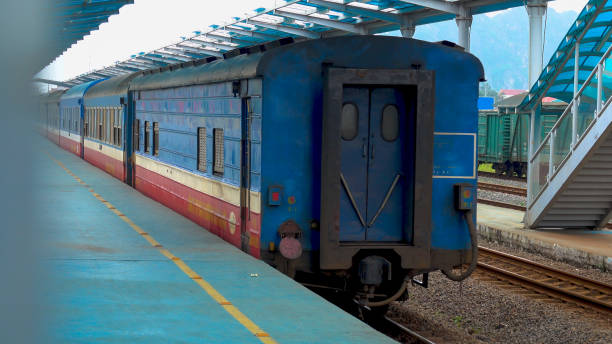 istock Long red and blue outbound express train leaves the empty platform in Hoi An. 1184436261