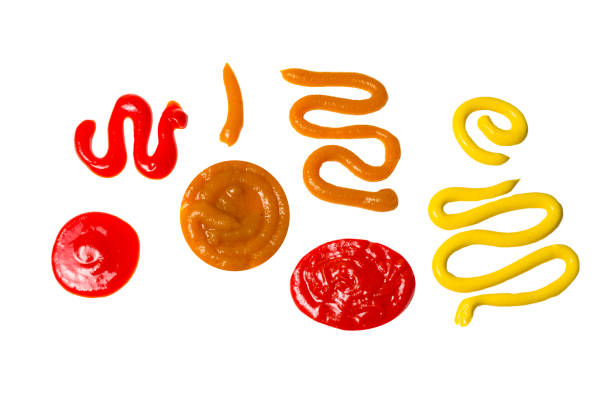 istock Ketchup and yellow sauce splashes isolated on white background. 1184436300