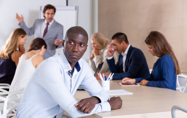 istock Frustrated African man with colleagues scolded by boss 1184437330