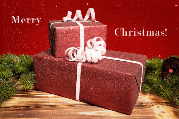 istock Christmas presents lie on a wooden table and a greeting message 1184437513