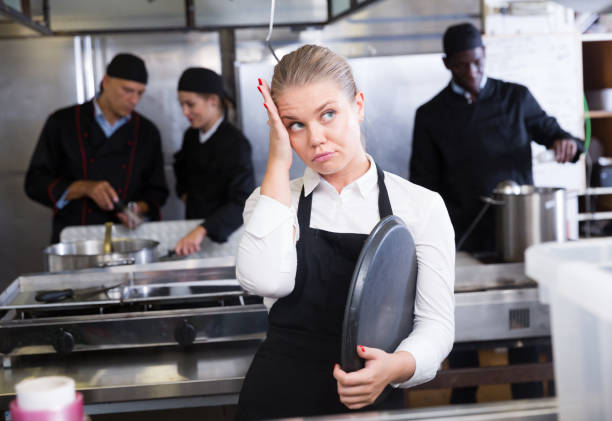 istock Upset waitress in kitchen of restaurant 1184444428