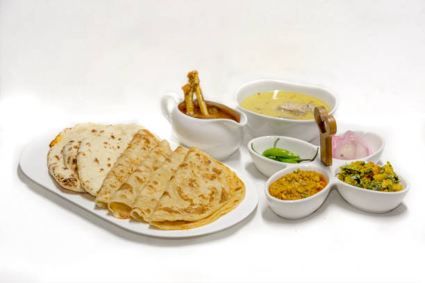 istock Butter chicken masala served with Parath with onion salad. 1184444890