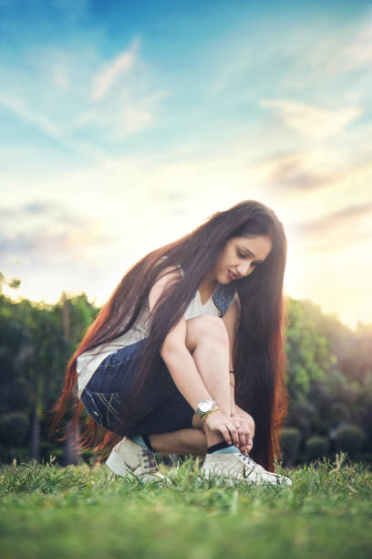 istock Indian Woman tying shoe laces 1184447430
