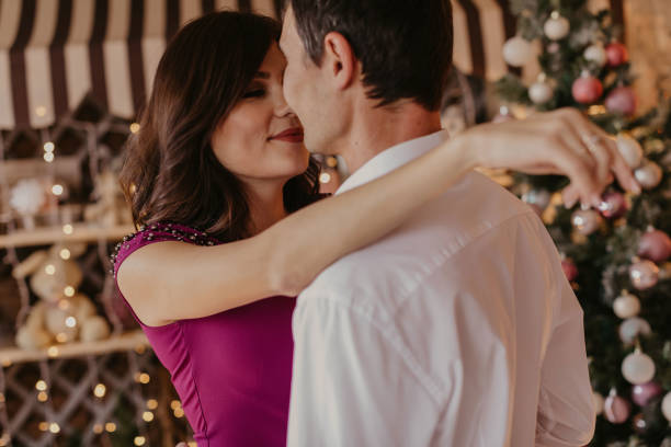 istock Happy couple celebrating Christmas together - Image 1184449745