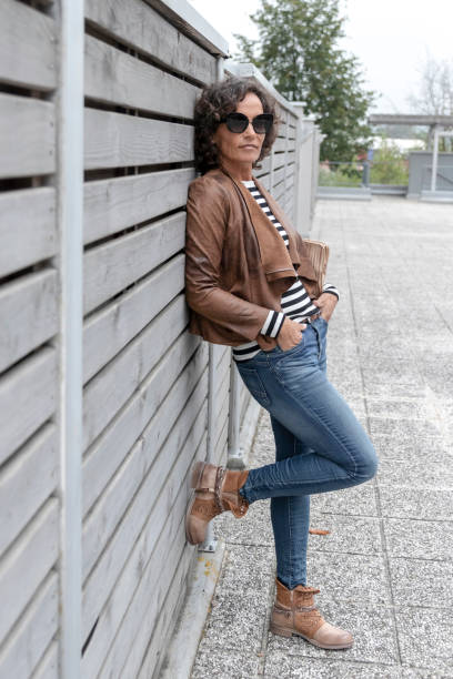 istock Woman leaning on the wall, posing 1184453264