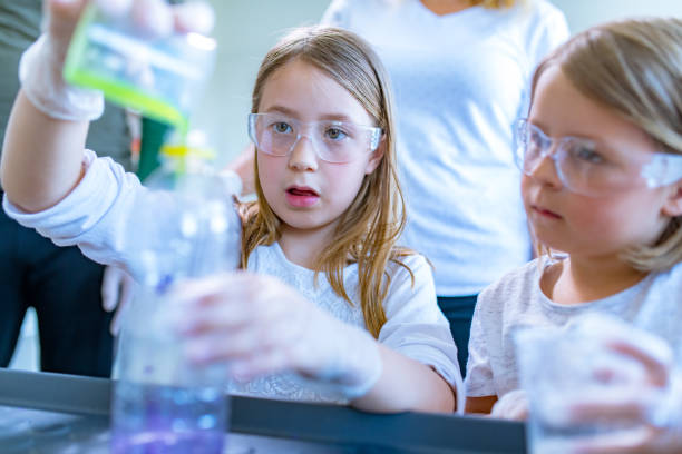 istock Schoolgirls on a chemistry class 1184453327