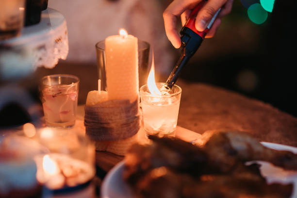 Asian chinese doing preparation and light up the candle before christmas party begin at roof top of house Light up the candle, prepare pinecone wreath, roast chicken, cup cake and foods for christmas party cigarette lighter stock pictures, royalty-free photos & images