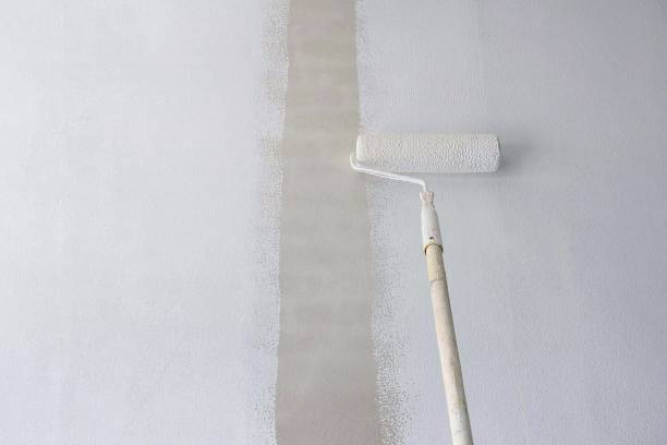 istock Painting primer white on cement wall 1184456955