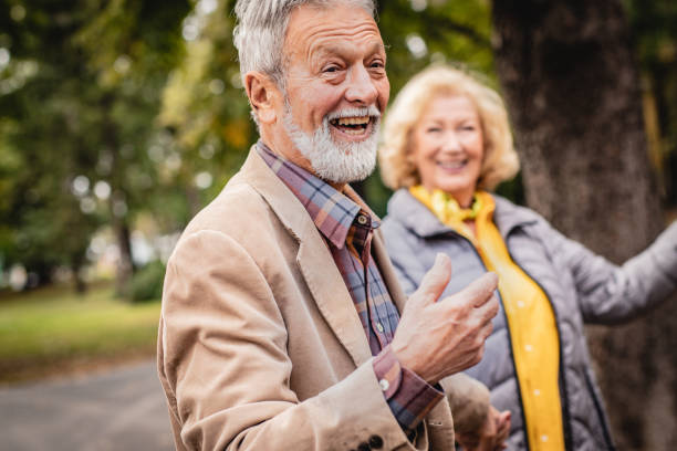 istock Senior couple enjoying in a sunny day in park 1184458096
