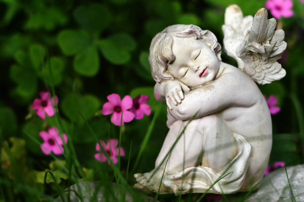 istock Cute angel and pink flowers 1184458816