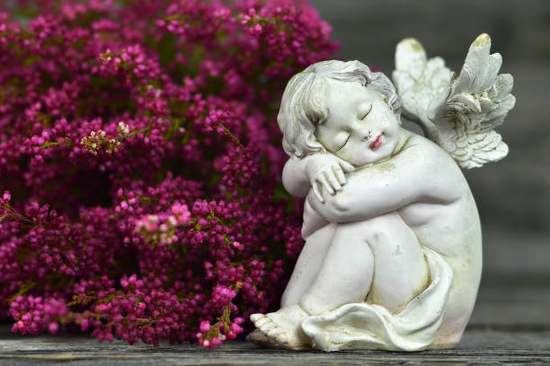 istock Guardian angel and pink flowers 1184458971