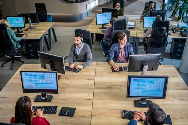 istock Call centre employees working in an office 1184460342