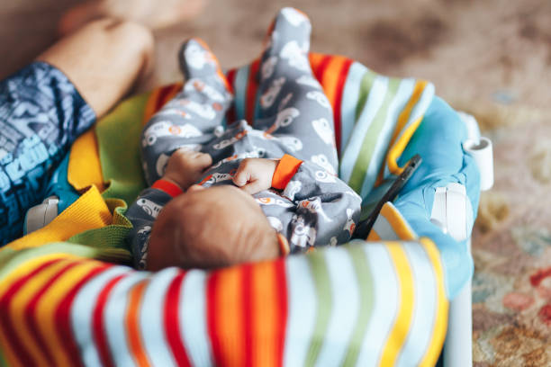 Baby boy lies on a deck-chair at home stock photo