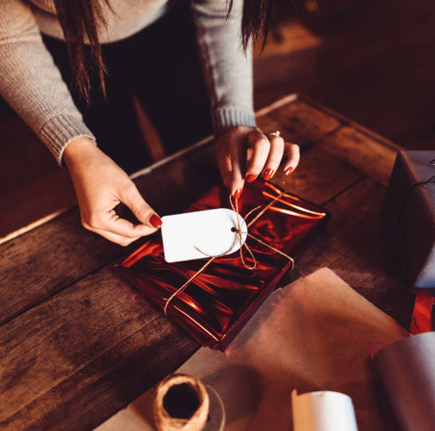 istock woman making the package for the christmas gift 1184461794